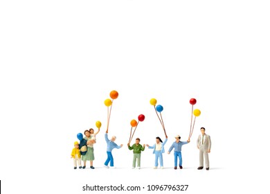 Miniature people : Happy family holding balloon on white background and copy space for text - Shutterstock ID 1096796327