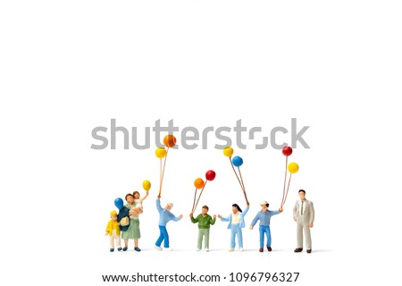 Miniature people : Happy family holding balloon on white background and copy space for text