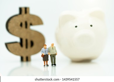 Miniature People: Happy Old People Standing On Coins Stack, Retirement Planning, Emergency Plan, Life Insurance And Financial Concept.