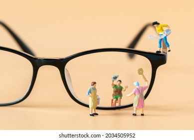 Miniature People Housewife Maid Or Worker Standing And Cleaning Dirty Reading Glasses Using As Hospitality Hotel Cleaning Service Business Or Health Care Healthy And Wellness Life Style Safety Concept