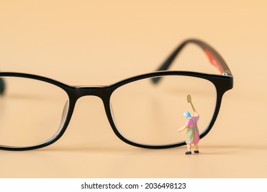 Miniature People Housewife Maid Or Worker Standing And Cleaning Dirty Reading Glasses Using As Hospitality Hotel Cleaning Service Business Or Health Care Healthy And Wellness Life Style Safety Concept