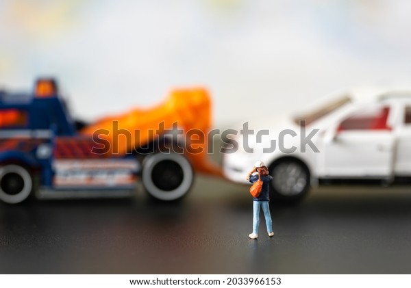 Miniature people Insurance Broker officer take\
photo car accident in public road using for Car Automotive\
maintenance repair fixed or replacement Service or Vehicle\
Insurance guarantee or drive\
safety