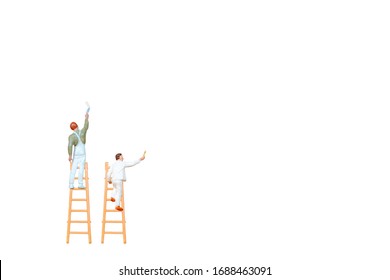 Miniature People With Ladder Holding Brush In Front Of A White Wall Background