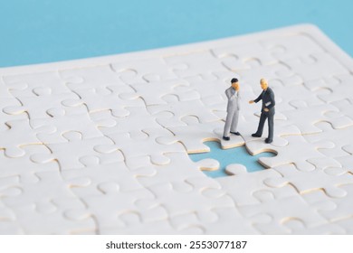 Miniature people looking for a jigsaw puzzle solution to a missing piece problem. - Powered by Shutterstock