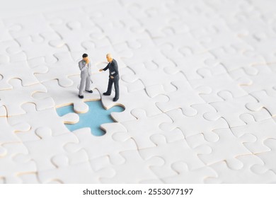 Miniature people looking for a jigsaw puzzle solution to a missing piece problem. - Powered by Shutterstock