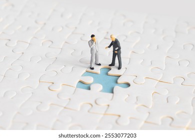 Miniature people looking for a jigsaw puzzle solution to a missing piece problem. - Powered by Shutterstock