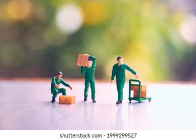 Miniature people, man carrying box using for logistic and business concept