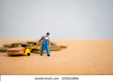 Miniature people, man pulling stack coins, using for logistic, business and finance concept - Powered by Shutterstock