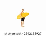 Miniature people man in a swimsuit, and holding a yellow surfboard, isolated on white background with clipping path