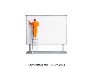 Miniature people Painter at The front of a whiteboard isolated on white background  with clipping path - Shutterstock ID 2115902813