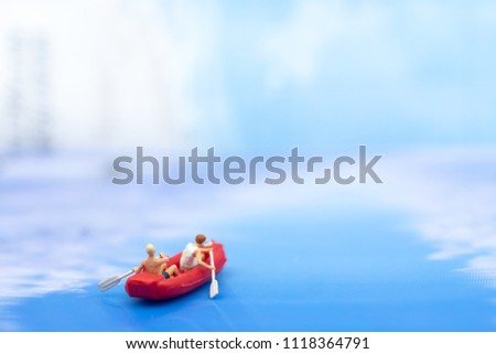 Miniature people, Rowing boat in the ocean. Image use for sports concept.