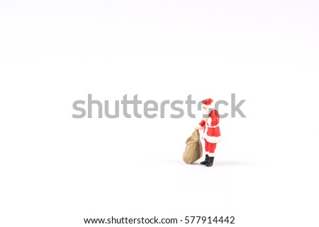 Miniature people Santa Claus on white background with space for text