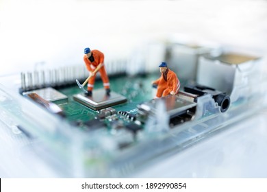 Miniature People Searching Or Checking For Bugs And Issue On Microchip, Mainboard Of Computer. Vulnerability Search And Security System Concept.