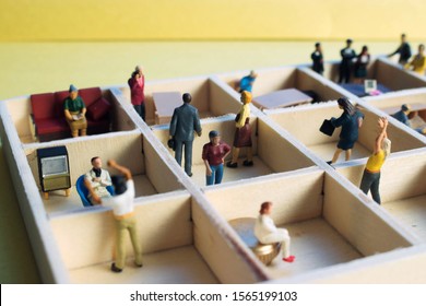 Miniature People Separated In Office Cubicles.Work In A Sterile Office Environment. People Divided In Little Boxes. Personal Space To Complete Your Work. Office Politics, Romance, Or Drama.