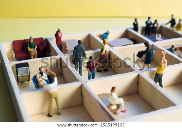 Miniature people separated in office cubicles.Work\
in a sterile office environment. People divided in little boxes.\
Personal space to complete your work. Office politics, romance, or\
drama.