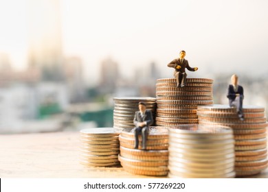 Miniature people: Small businessmen sitting on stack of coins, Money, Financial, Business Growth concept. - Shutterstock ID 577269220