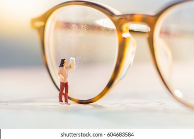 Miniature People : Small Figure Woman Cleaning Glasses Using As Business Background.