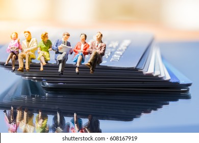 Miniature People: Small Figures Toy Business People Sitting And Discuss About Business Deal On Stack Of Credit Cards, Banking Finance Technology, Shopping And E-commerce Concept