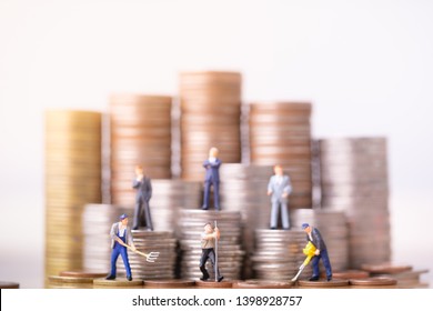 Miniature People Standing On A Pile Of Coins. Inequality And Social Class. Income And Economic Inequality Concept. Inequality In Social Class, Ideology, Gender, Racial And Ethnic And Health.