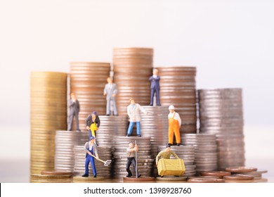 Miniature People Standing On A Pile Of Coins. Inequality And Social Class. Income And Economic Inequality Concept. Inequality In Social Class, Ideology, Gender, Racial And Ethnic And Health.