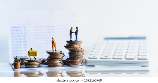 Miniature People Standing On A Pile Of Coins. Inequality And Social Class. Income And Economic Inequality Concept. Inequality In Social Class, Ideology, Gender, Racial And Ethnic And Health.