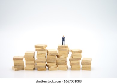 Miniature people standing on stack of wood Investment Analysis Or big data Analysis. as background business concept ,big data concept and Money, Financial, Business Growth concept with copy space.
