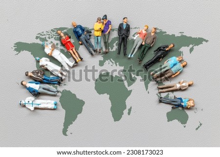 Miniature people standing on the world map with gray background , World Population Day concept