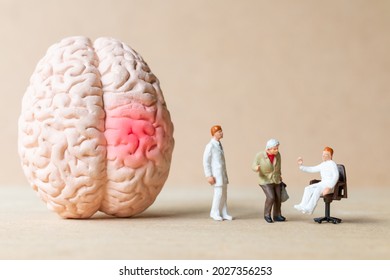 Miniature People Surgeon Spoke With Patient About Brain Injuries. World Stroke Day Concept.