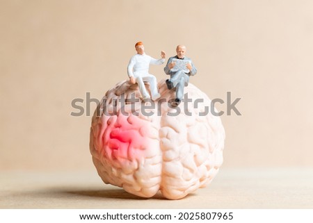 Miniature people Surgeon spoke with patient about brain injuries. World Stroke Day concept.