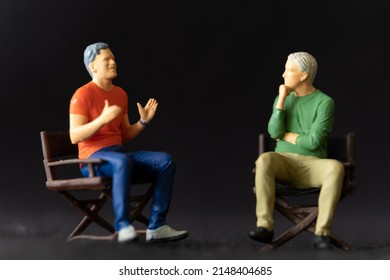 Miniature People Therapist And Patient Talking Together, He Is Helping Him To Cope With A Stressful Situation