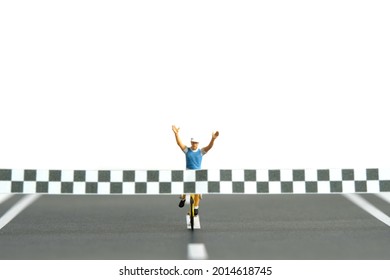 Miniature People Toy Figure Photography. A Biker With Finish Line