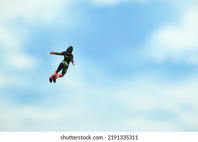 Miniature People Toy Figure Photography. A Men Doing Sky Diving Jump In Cloudy Bright Day. Image Photo