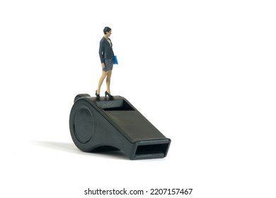 Miniature people toy figure photography. Whistle blower concepts. A businesswoman standing above black whistle. Isolated on white background. Image photo - Shutterstock ID 2207157467