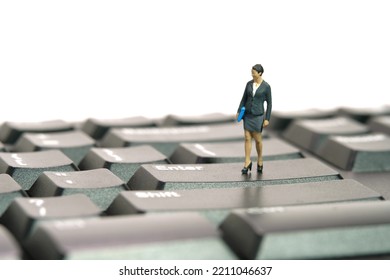 Miniature people toy figure photography. Typing job concept. A businesswoman standing above black keyboard. Isolated on white background. Image photo - Shutterstock ID 2211046637