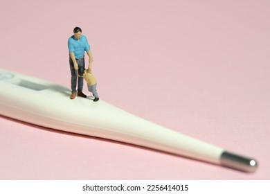 Miniature people toy figure photography. Refusing body temperature check concept. A father and son standing above thermometer. Isolated pink background. Image photo - Powered by Shutterstock