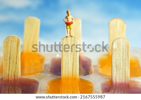 Miniature people toy figure photography. Creative summer pool vacation concept. Kids with rubber tube standing above pudding jelly ice cream stick ready to jump. Image photo