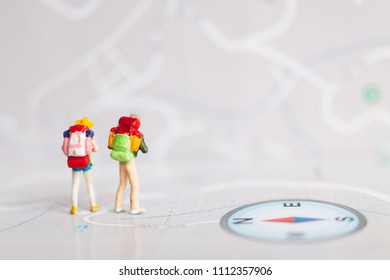 Miniature People : Traveler With Backpack Walking On Map , Travel And Adventure Concepts.