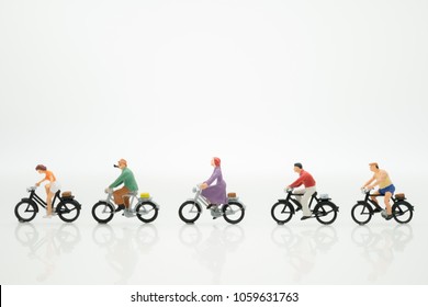 Miniature people : Travelers riding bicycle with copy space using as background traveling or exploring the world, budget travel, health care concepts. - Shutterstock ID 1059631763