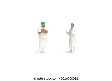 Miniature People : Two Doctors Wearing Surgical Hygiene Protective Masks On White Background