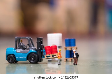 Miniature People : Two Engineers Standing In Front Of Drums And Tote At The Warehouse And Discuss On Storage Management With Copy Space, Business, Industrial Concept