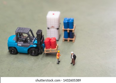 Miniature People : Two Engineers Standing In Front Of Drums And Tote At The Warehouse And Discuss On Storage Management With Copy Space, Business, Industrial Concept