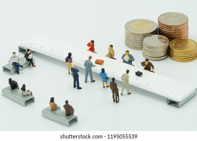 Miniature People Use Cash Deposit. At The Bank Counter Or Financial Institution. There Are Many Users. As Background Business Concept And Saving Concept With  Copy Spaces For Your Text Or Design.