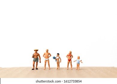 Miniature people wearing swimsuit standing on the beach  , vacation concept - Powered by Shutterstock