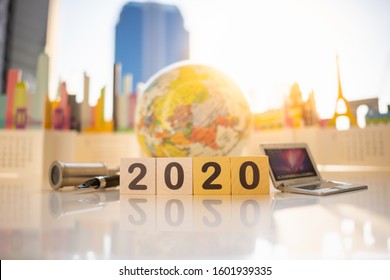 Miniature People: Wood Block Number 2020 With Binoculars, Laptop On Blurred City Scape Using As Background Choice Of The Best Suited Employee, HR, HRM, HRD, Job Recruiter Concepts.