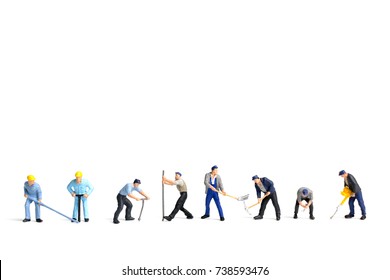 Miniature people worker holding tool on white background,construction concept