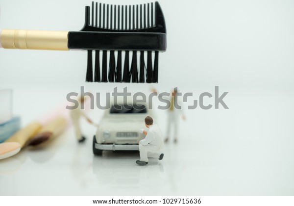 Miniature\
people: Worker painting and make up and modify car with copy space\
using as background car care, business\
concept.