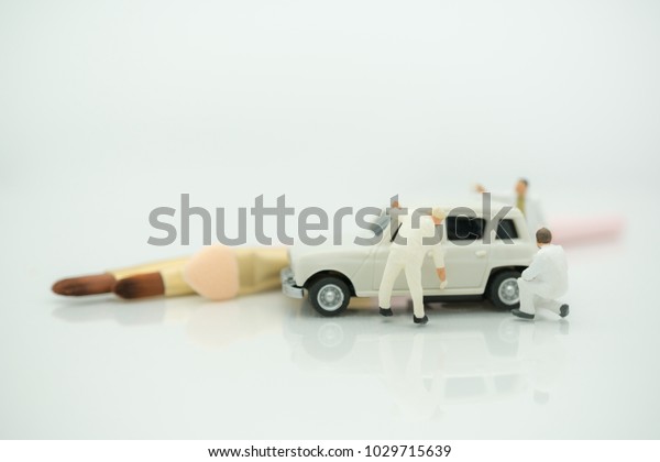 Miniature
people: Worker painting and make up and modify car with copy space
using as background car care, business
concept.