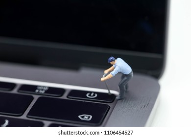 Miniature people : worker pull a  button of power laptop.