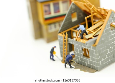 Miniature People : Worker Team For Building Home ,Image Use For Construction, Business Concept,house Repair Or Home Renovating