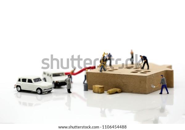Miniature people : worker team with house and\
car,repair  or home\
renovating